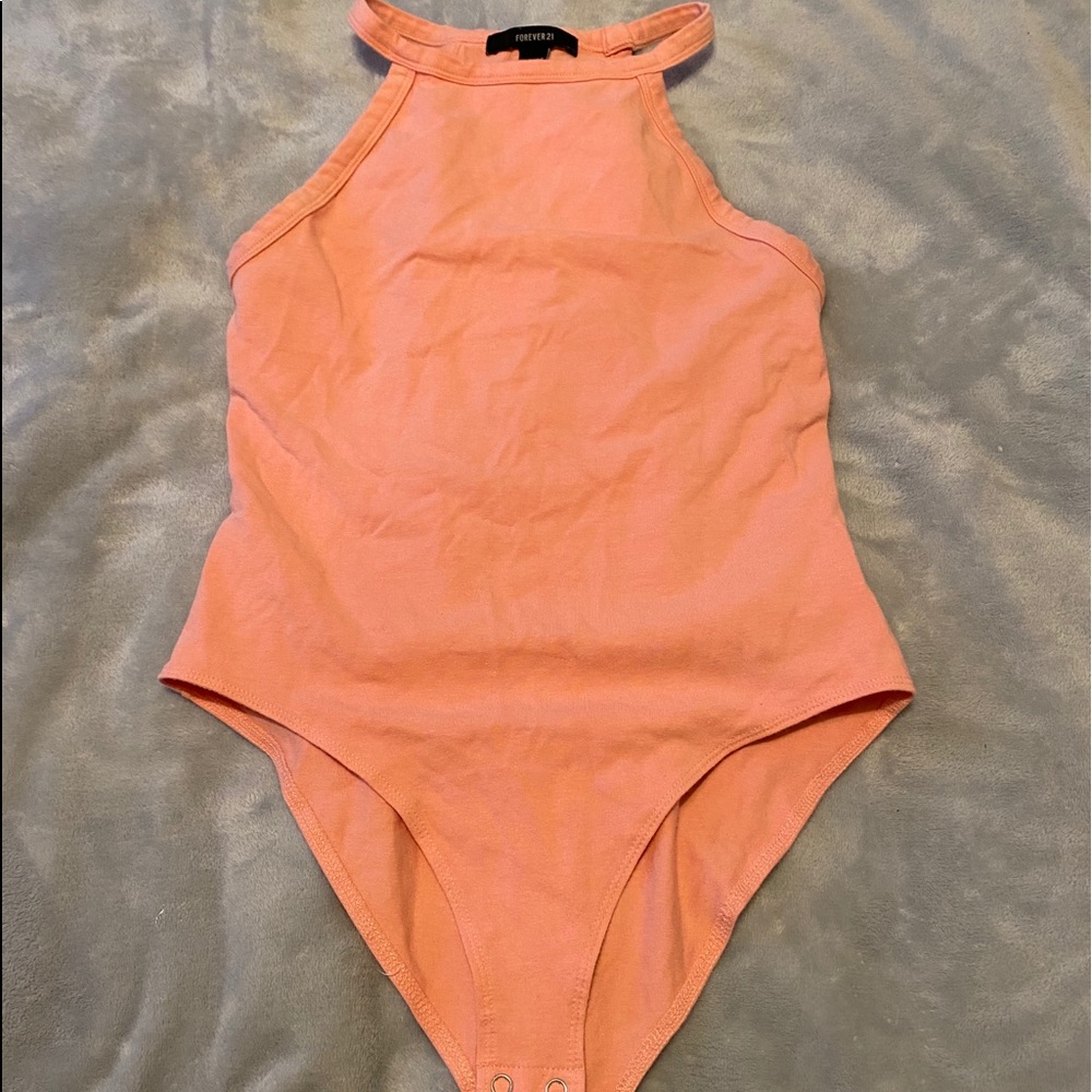 Two body suits. One pink and the other yellow